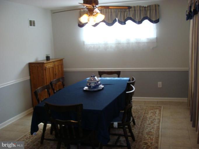12818 Crisfield Road Silver Spring, MD 20906 - Photo 3 of 21 a view of a dining room with furniture and wooden floor