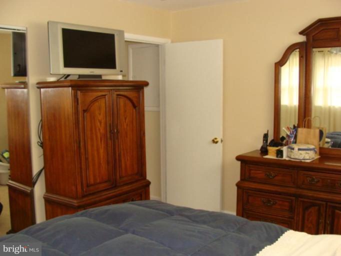 12818 Crisfield Road Silver Spring, MD 20906 - Photo 6 of 21 a living room with furniture and a flat screen tv