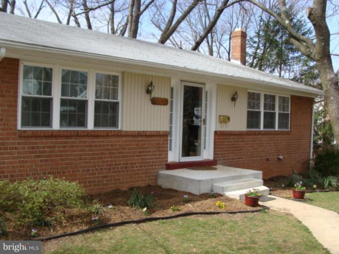 12818 Crisfield Road Silver Spring, MD 20906 - Photo 8 of 21 front view of a brick house with a yard