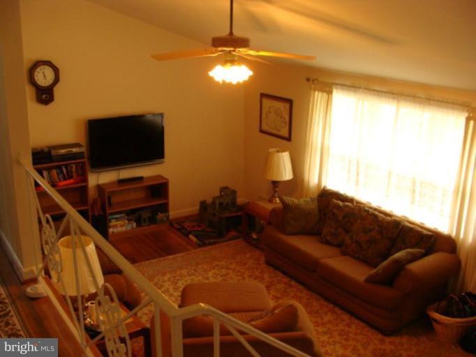 12818 Crisfield Road Silver Spring, MD 20906 - Photo 10 of 21 a living room with furniture a flat screen tv and a window