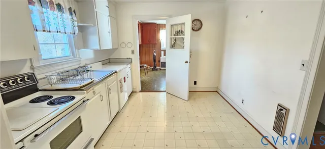 a kitchen with a sink a stove a refrigerator and window