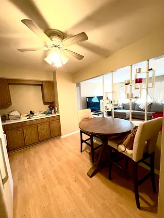 a living room with furniture a flat screen tv and a table