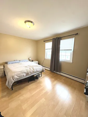 a spacious bedroom with a bed and a window