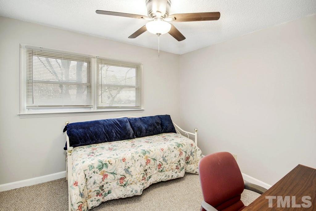 401 Buck Jones Road Raleigh, NC 27606 - Photo 16 of 21 a bedroom with a bed and window