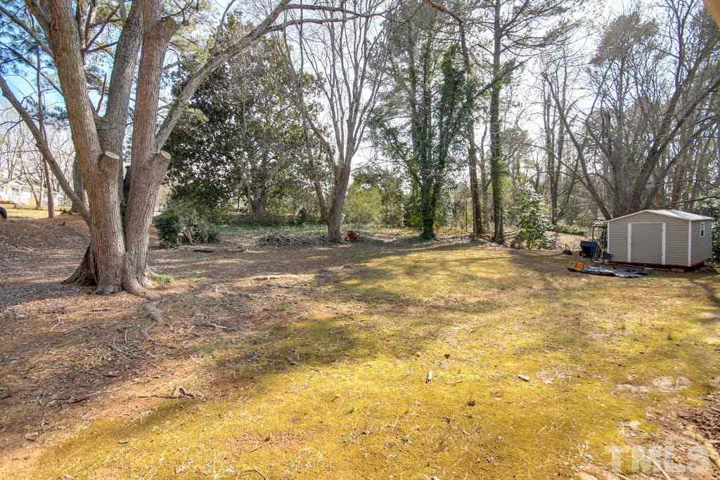 401 Buck Jones Road Raleigh, NC 27606 - Photo 18 of 21 a view of a yard with trees