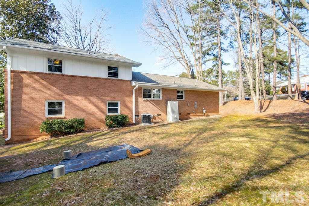 401 Buck Jones Road Raleigh, NC 27606 - Photo 19 of 21 a front view of a house with a yard and garage