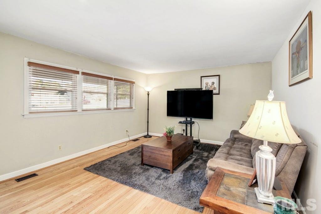 401 Buck Jones Road Raleigh, NC 27606 - Photo 4 of 21 a living room with furniture and a flat screen tv