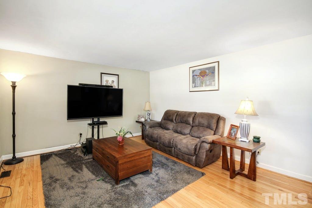 401 Buck Jones Road Raleigh, NC 27606 - Photo 5 of 21 a living room with furniture and a flat screen tv