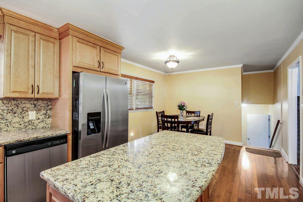 401 Buck Jones Road Raleigh, NC 27606 - Photo 7 of 21 a kitchen with refrigerator cabinets and wooden floor