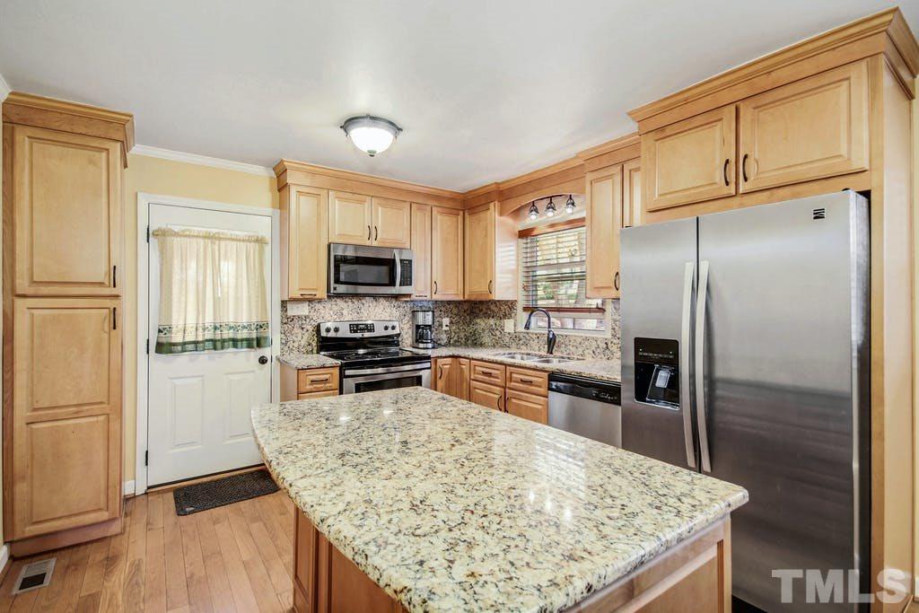 401 Buck Jones Road Raleigh, NC 27606 - Photo 8 of 21 a kitchen with stainless steel appliances granite countertop a refrigerator oven stove a sink and dishwasher