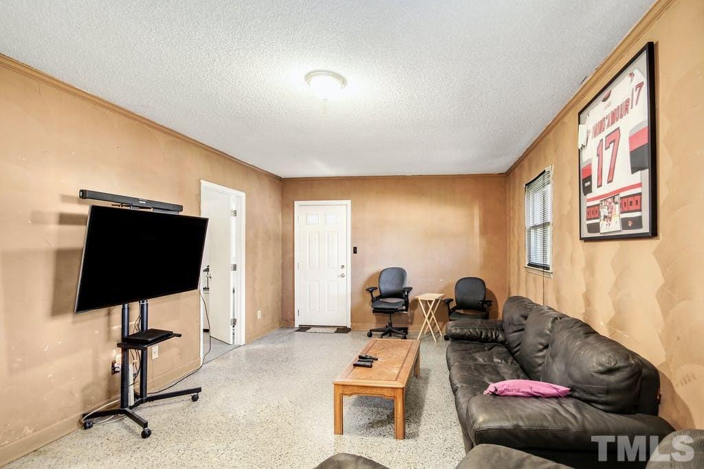 401 Buck Jones Road Raleigh, NC 27606 - Photo 10 of 21 a living room with furniture and a flat screen tv