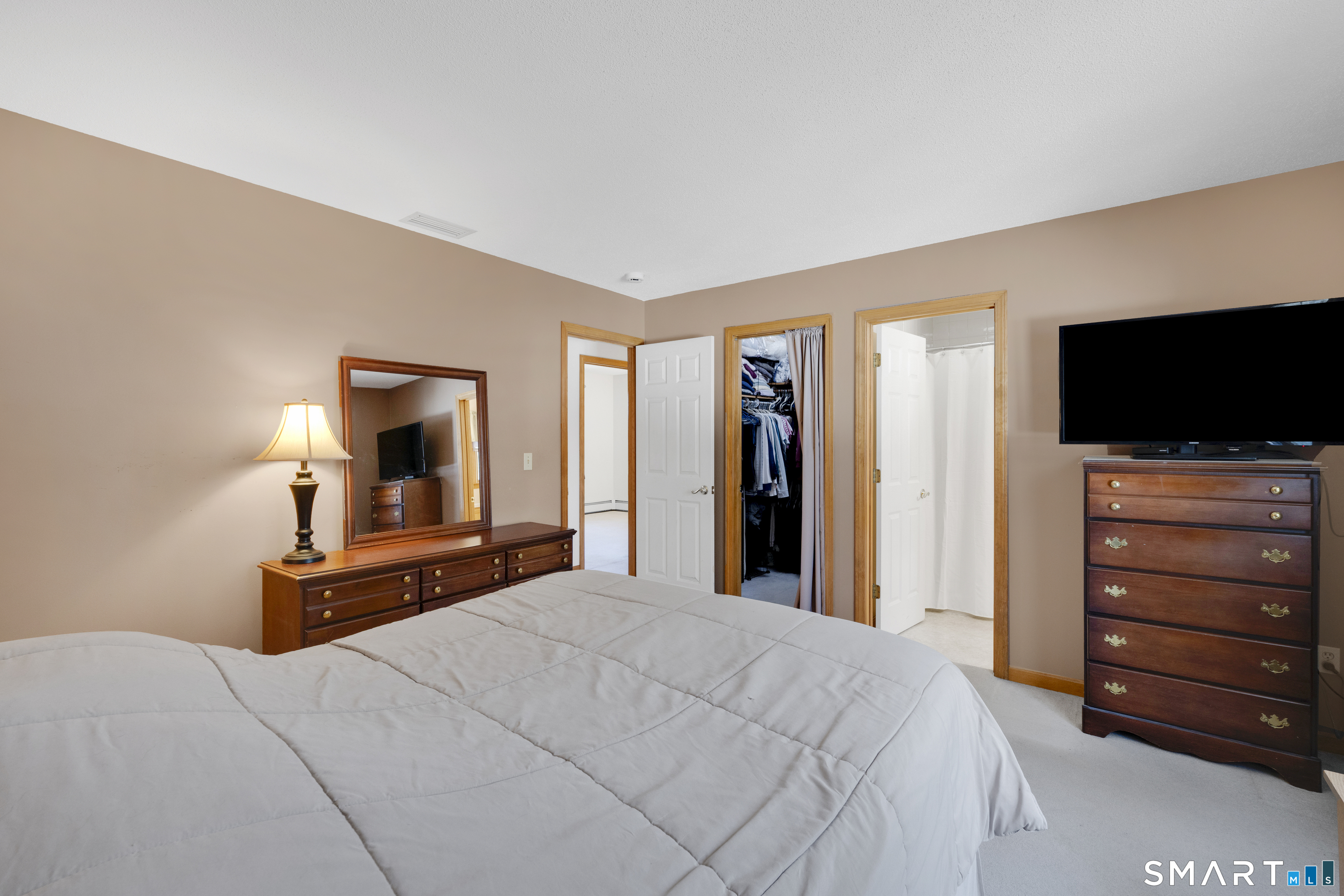 357 North Maple Street Enfield, CT 06082 - Photo 19 of 37 a bedroom with a bed and a flat screen tv