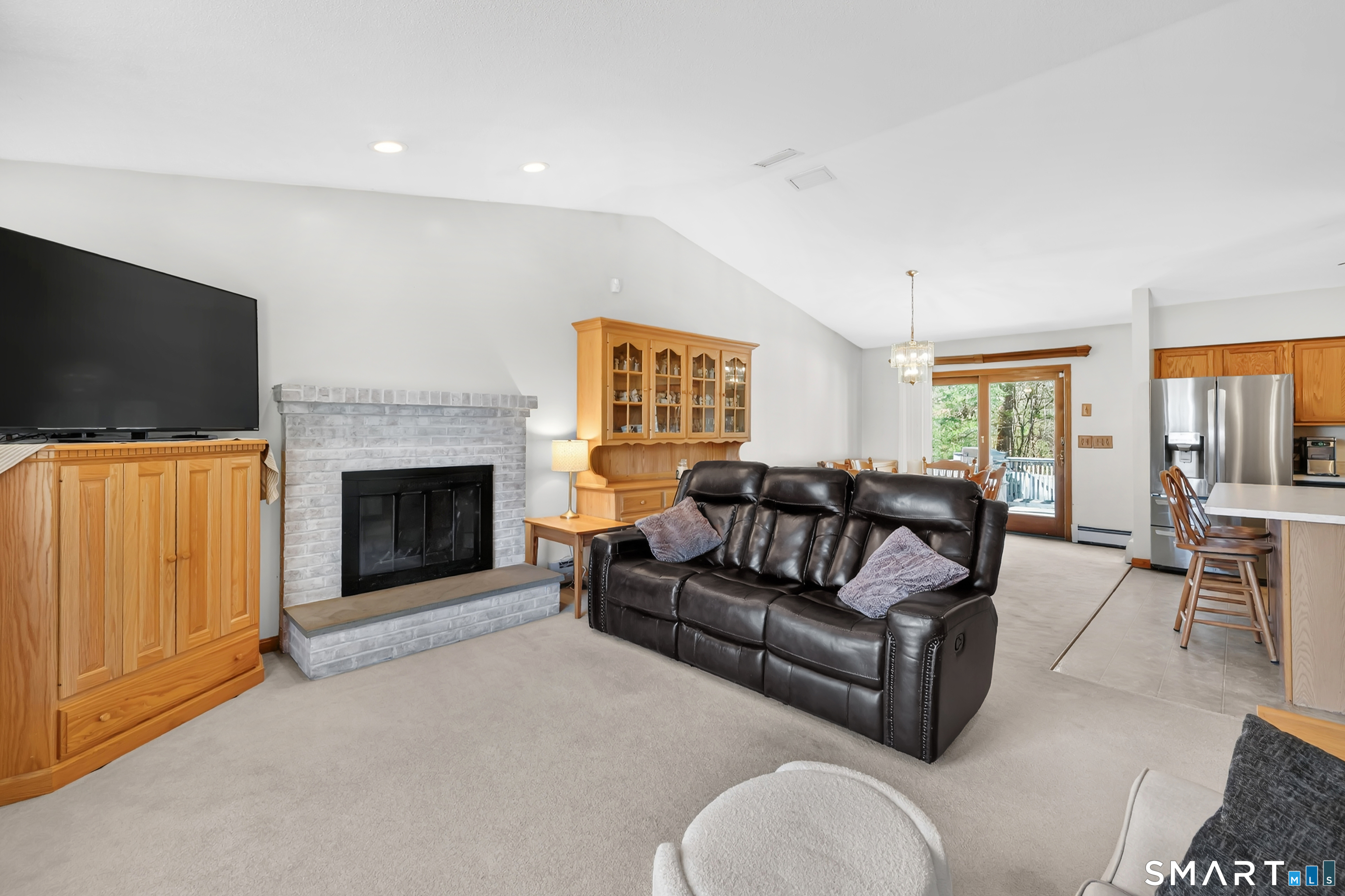 357 North Maple Street Enfield, CT 06082 - Photo 7 of 37 a living room with furniture a flat screen tv and a fireplace