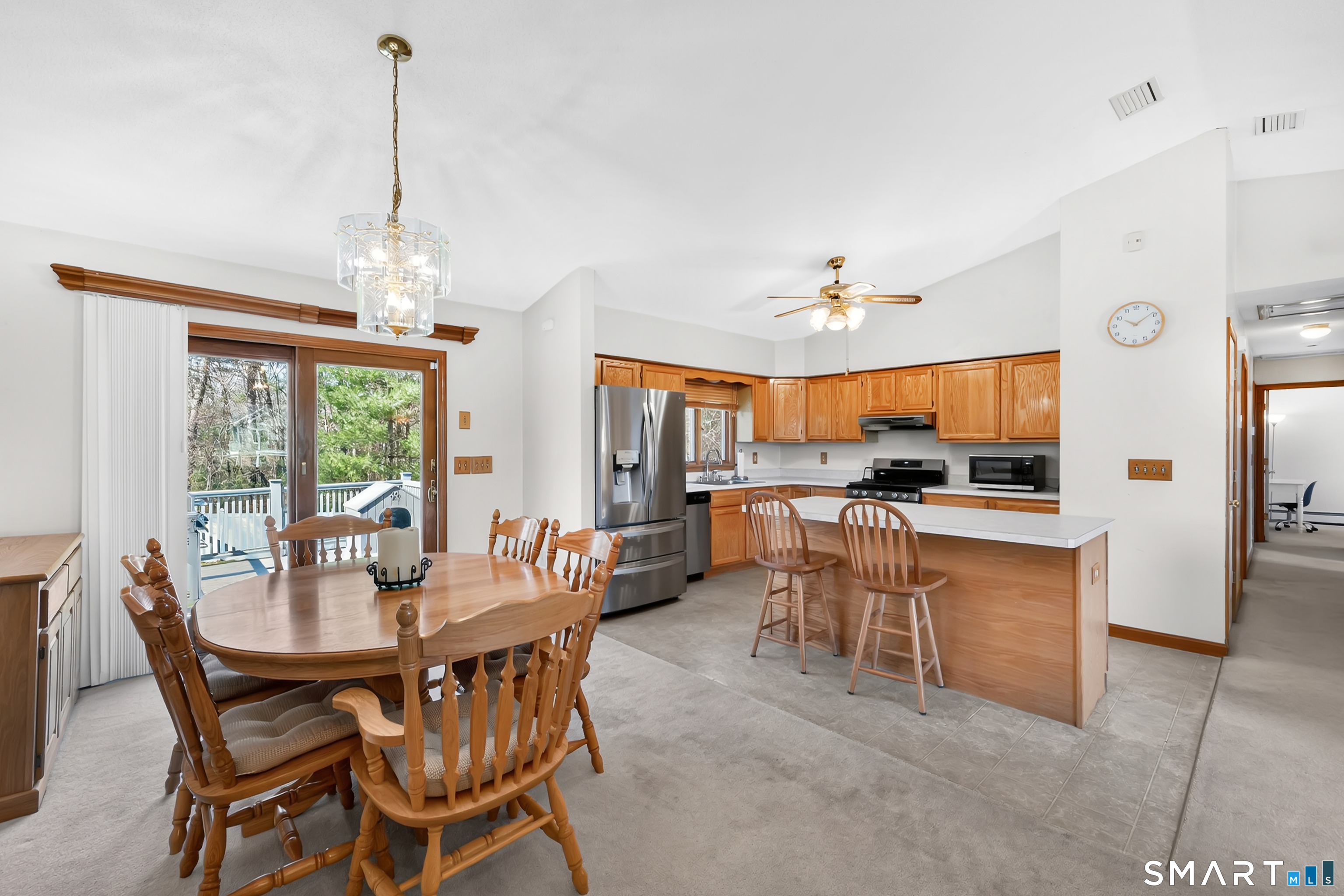 357 North Maple Street Enfield, CT 06082 - Photo 10 of 37 a view of a dining room and livingroom with furniture wooden floor a chandelier