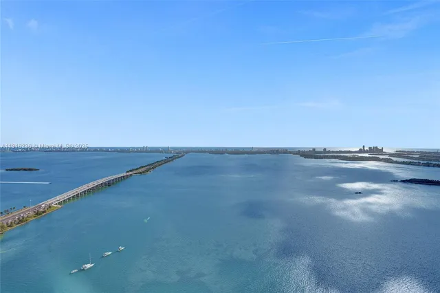 a kitchen with stainless steel appliances kitchen island granite countertop a sink stove and wooden floor