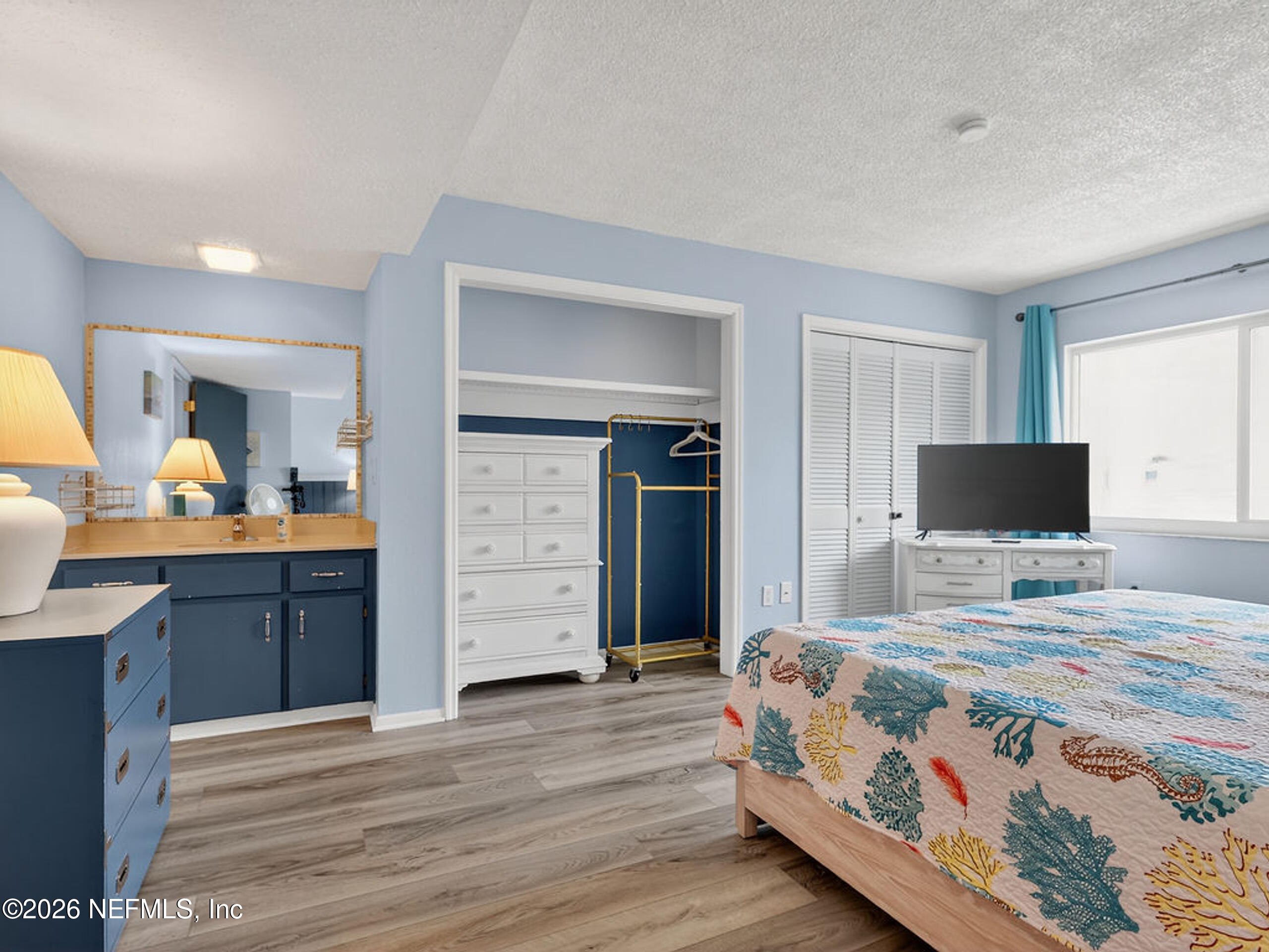 1 Ocean Trace Road, Unit 230 St. Augustine Beach, FL 32080 - Photo 21 of 50 a bedroom with a bed and a flat screen tv
