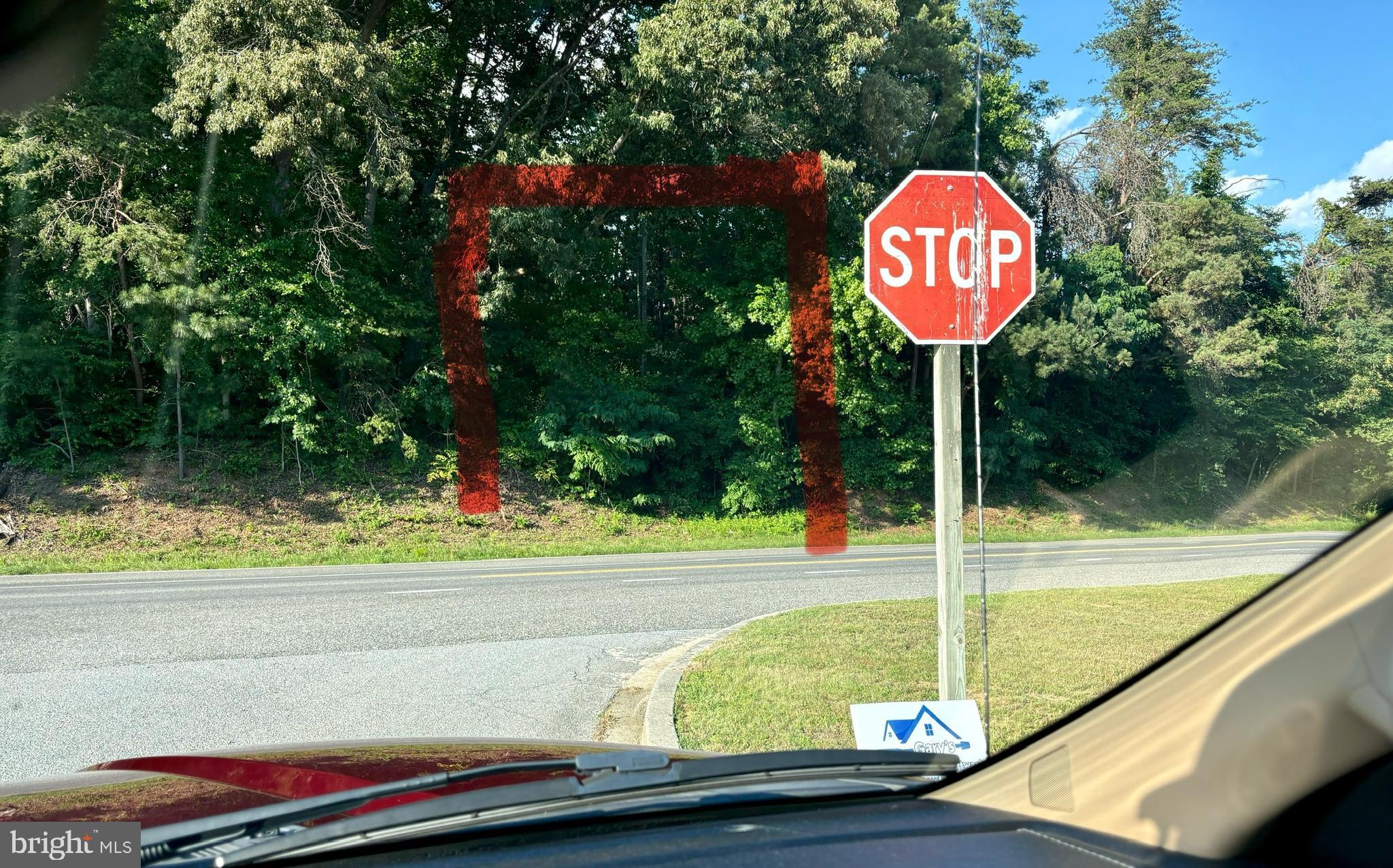 17012 Prince Frederick Road Hughesville, MD 20637 - Photo 5 of 6 a view of a park with a bench and a sign board