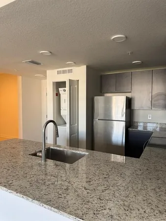 a kitchen with a refrigerator and a sink