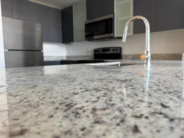 a view of living room with stainless steel appliances cabinets