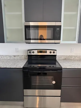 a stove top oven sitting inside of a kitchen