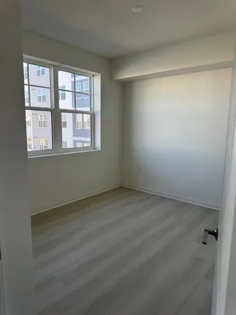 an empty room with a empty space and windows