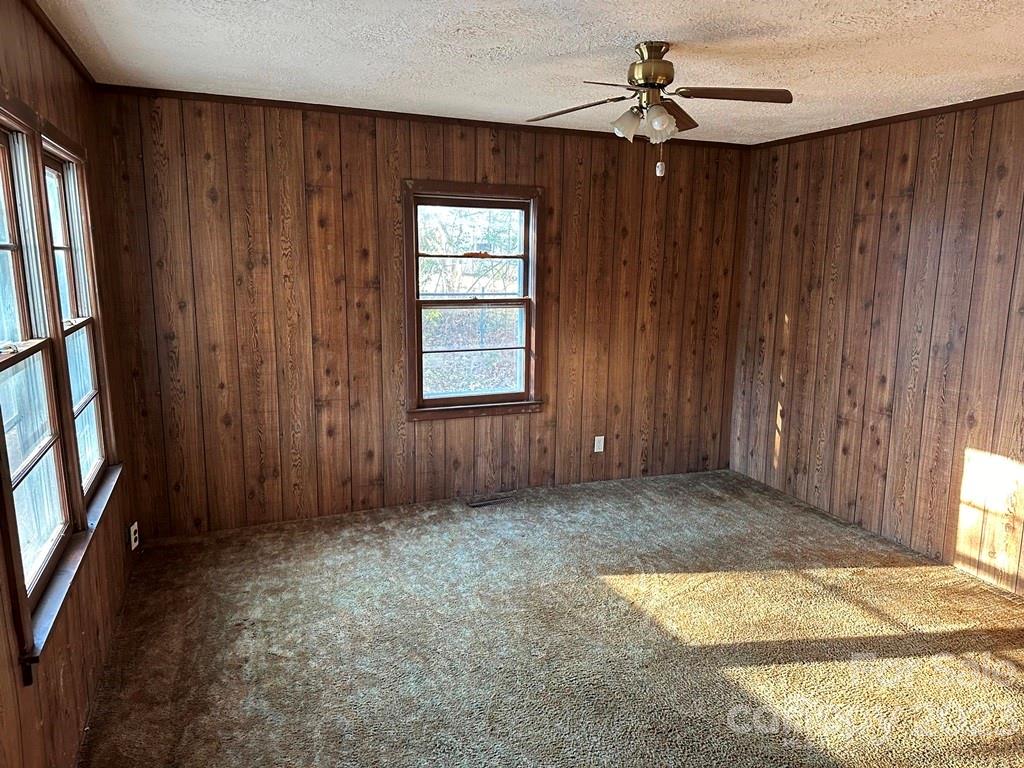 91 Beaver Street Tryon, NC 28782 - Photo 5 of 13 an empty room with windows & cabinet curtains