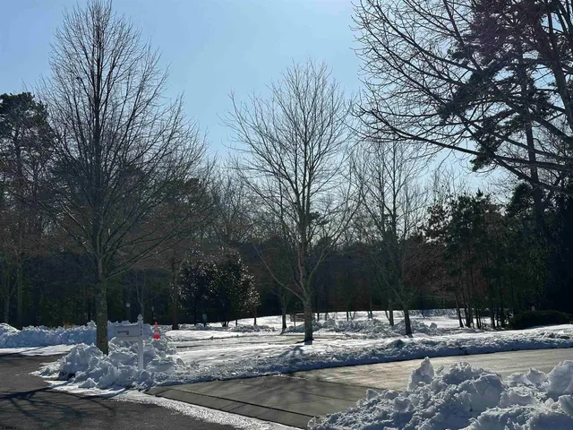 a view of a building with a snow on the road