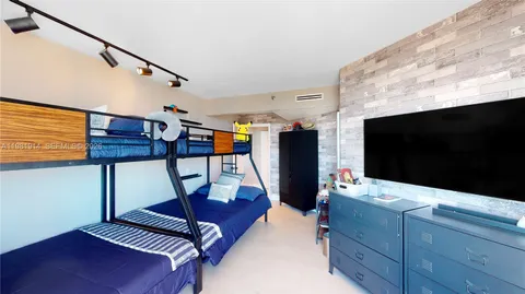 a living room with furniture a flat screen tv and rug