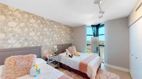 a bedroom that has a bed and a table in it