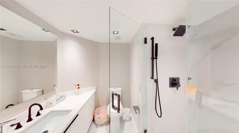 a bathroom with a tub sink a mirror and shower