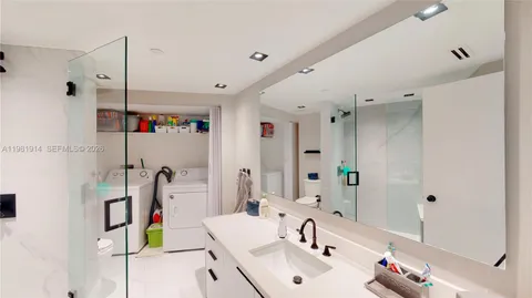 a bathroom with a tub sink and a mirror
