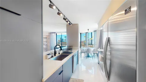 a kitchen with stainless steel appliances a refrigerator and a sink
