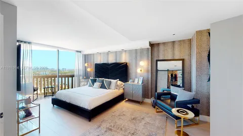 a bedroom with a bed and large window