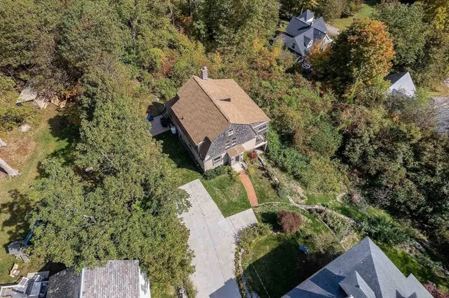 an aerial view of a house with a yard
