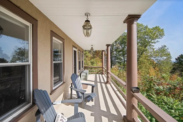 a view of a balcony with furniture