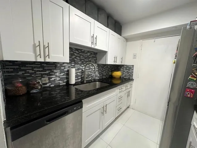 a kitchen with stainless steel appliances granite countertop a stove microwave and refrigerator