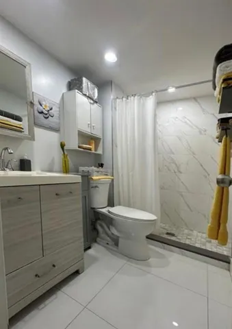 a bathroom with a sink toilet and shower