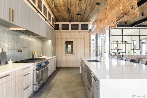 a large white kitchen with a large window