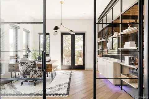 a view of a dining room with furniture large windows and wooden floor