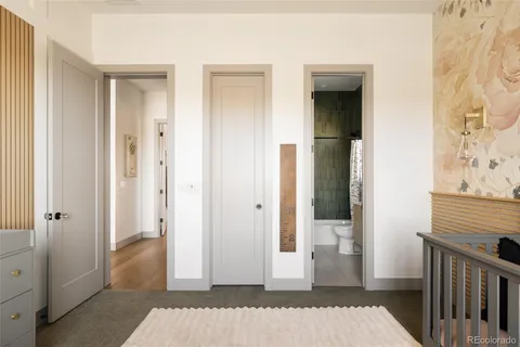 a bedroom with a bed and large windows