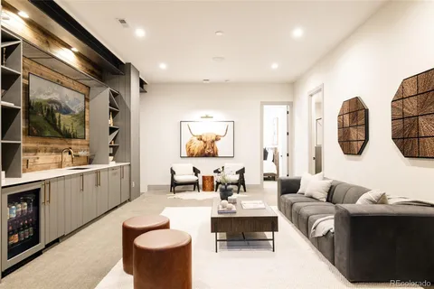 a living room with furniture a chandelier and a large window