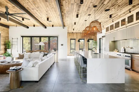 a living room with furniture and a chandelier