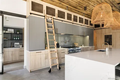 a kitchen with cabinets and chairs