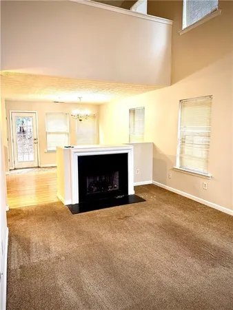 a view of empty room with a fireplace
