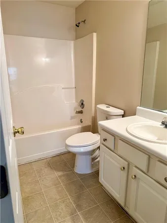 a bathroom with a toilet a sink and bathtub