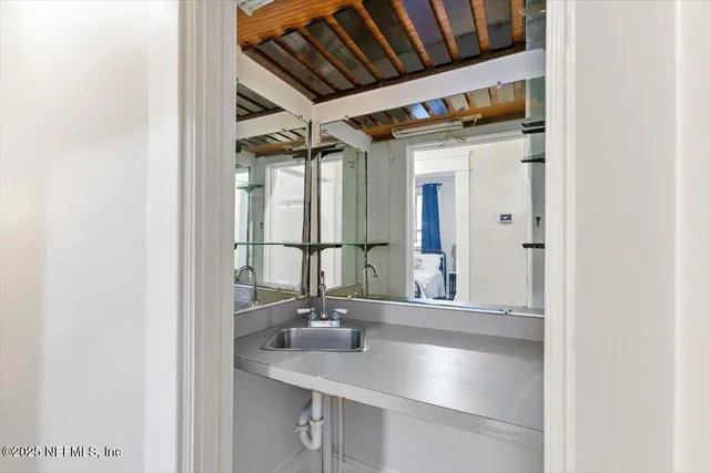 a bathroom with a sink and a mirror