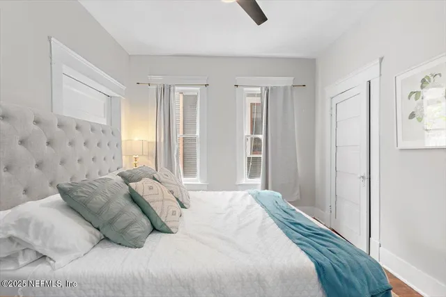 a bedroom with a bed and a window