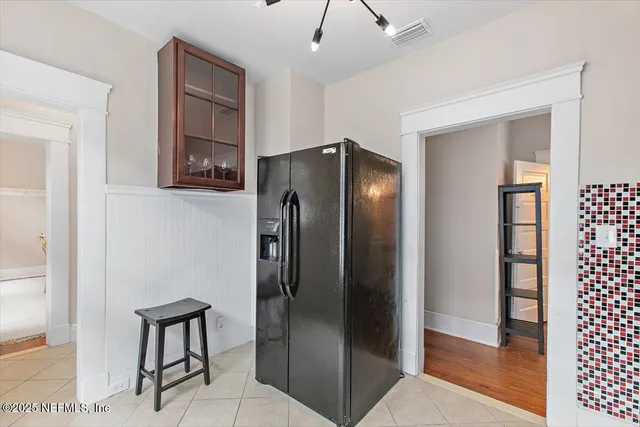 a metallic refrigerator freezer sitting in a kitchen