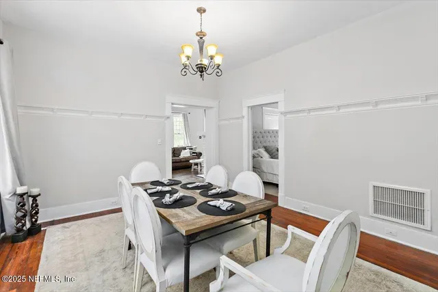 a view of a dining room with furniture and chandelier