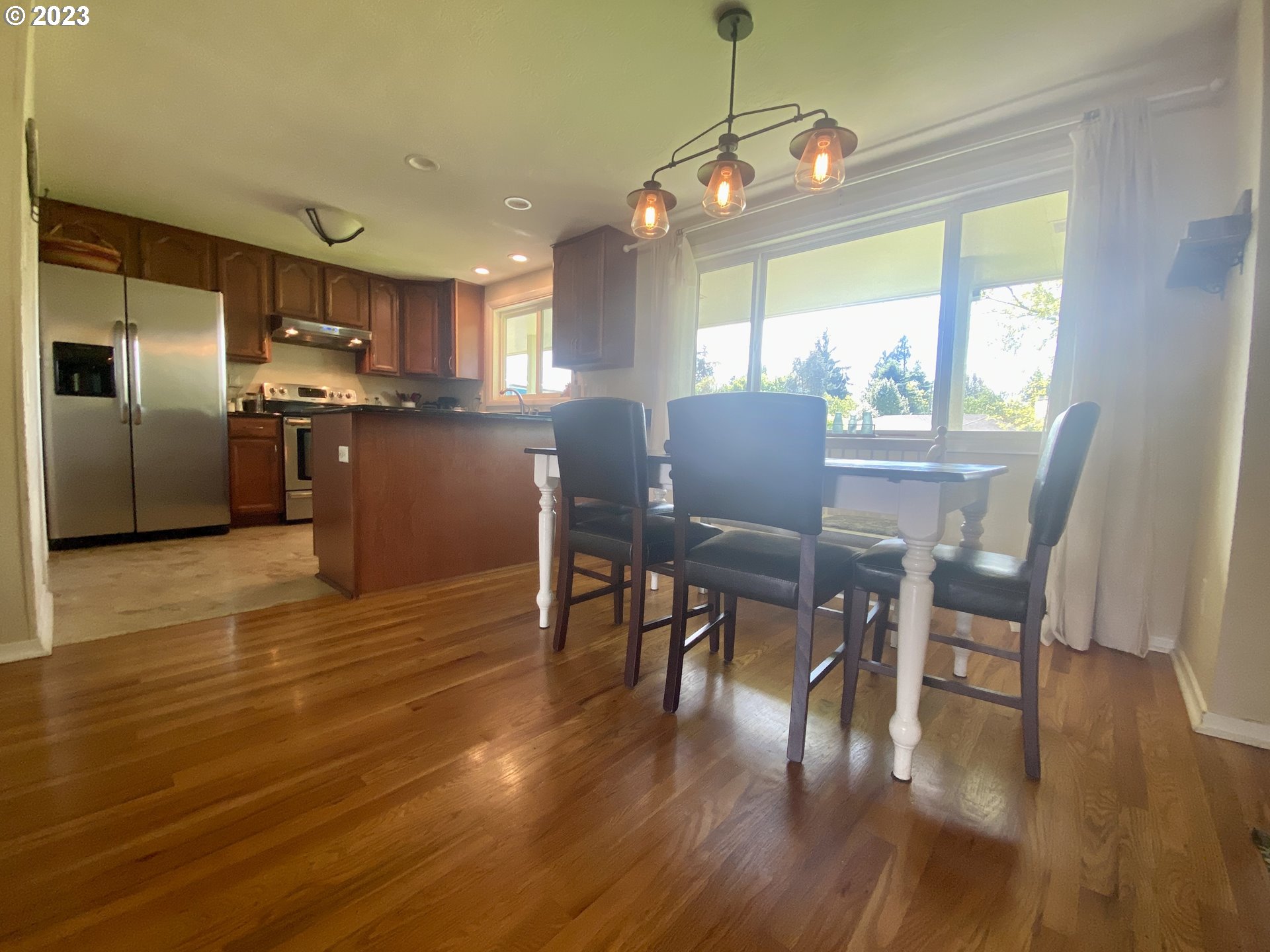 2181 5th Street Springfield, OR 97477 - Photo 4 of 39 a view of a dining room with furniture window and wooden floor